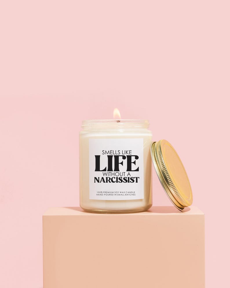 a candle sitting on top of a pink block