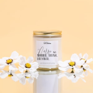 a jar of white flowers sitting on top of a table