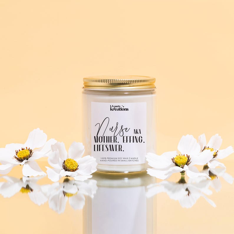 a jar of white flowers sitting on top of a table
