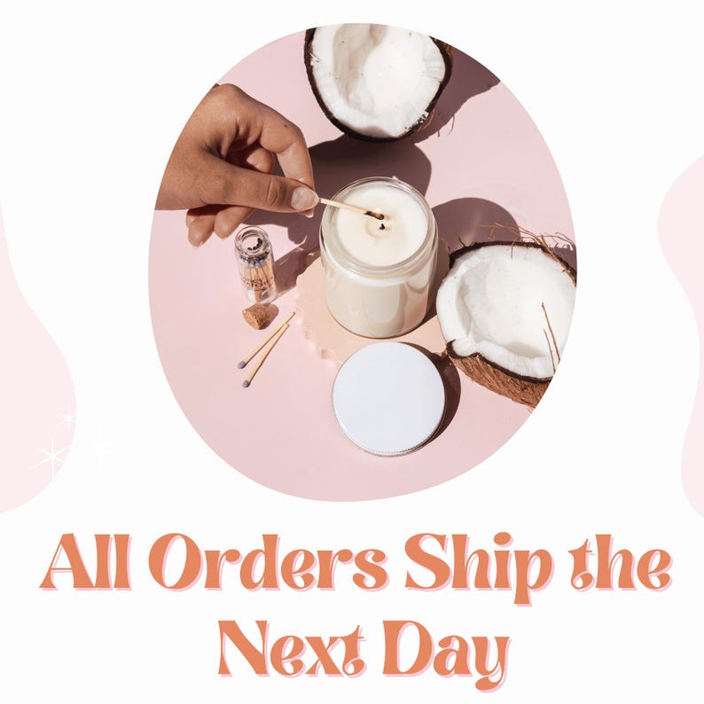 May include: A white candle in a glass jar with a wooden wick being lit with a match. The candle is surrounded by two halves of a coconut, matches, and a small glass jar of matches. The background is a light pink.