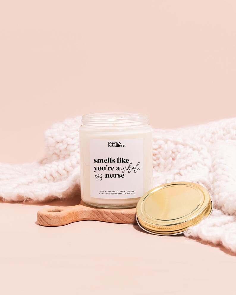a jar of honey next to a wooden spoon