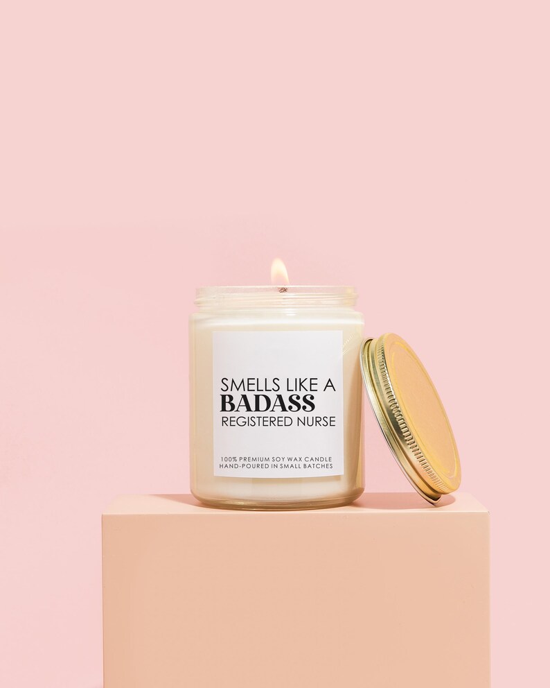 a candle sitting on top of a pink block