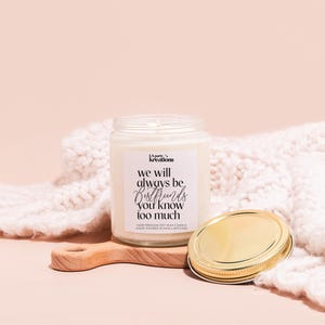 a jar of wax next to a wooden spoon