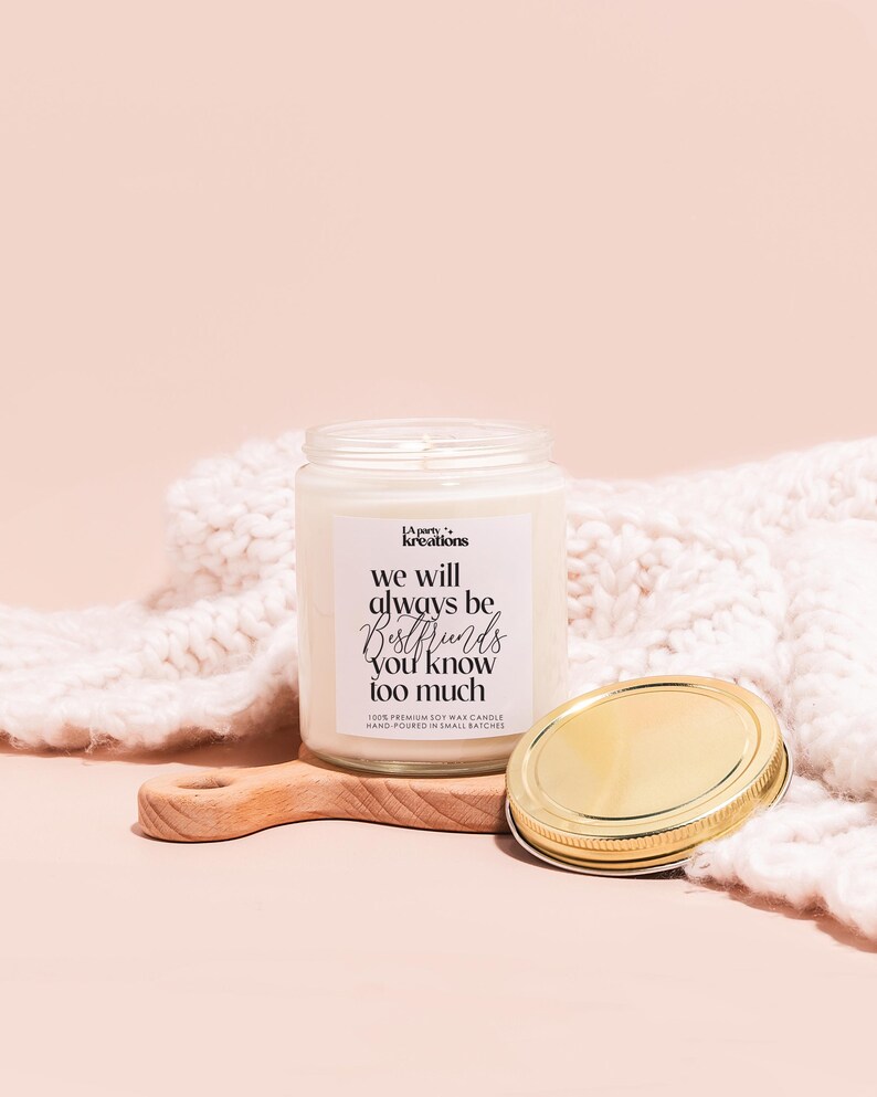 a jar of wax next to a wooden spoon