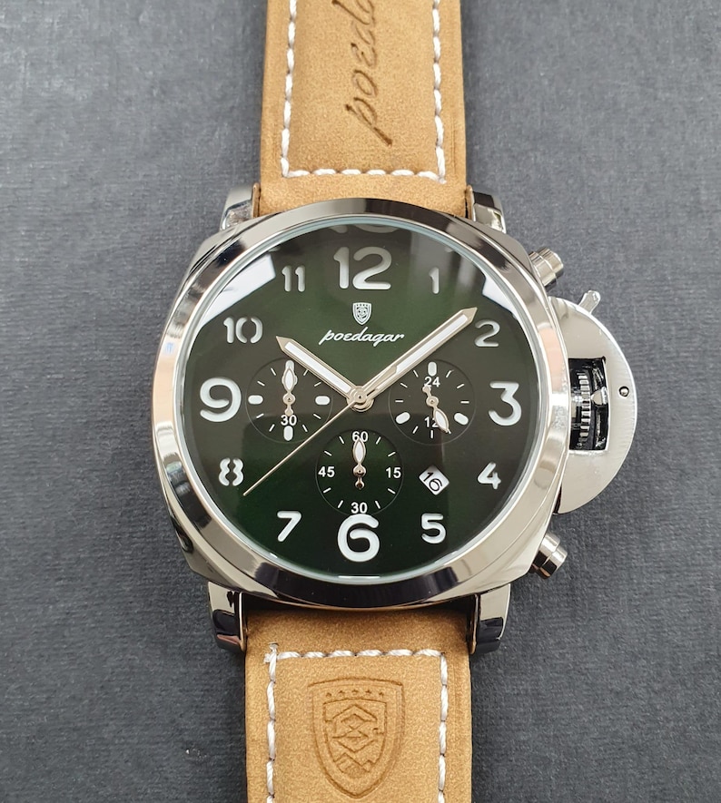 May include: A silver chronograph wristwatch with a green face and brown leather band. The watch face has white numbers and hands, and the brand name "poedagar" is printed in black.