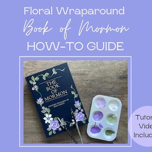 May include: A how-to guide for creating a floral wraparound for a Book of Mormon. The image shows a book with a floral design and a paint palette with purple and green paint.