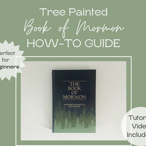 May include: A dark blue book titled "The Book of Mormon" with a tree design at the bottom. The image includes text that reads "Tree Painted Book of Mormon HOW-TO GUIDE" and "Tutorial Video Included!"