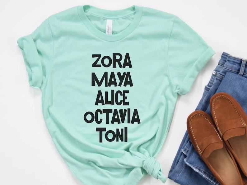 May include: A light green t-shirt with black text that reads "Zora Maya Alice Octavia Toni".