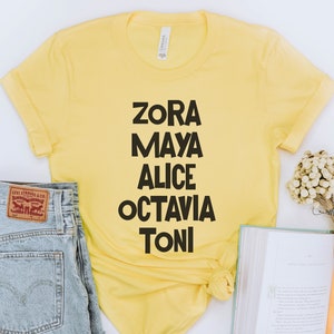May include: Yellow t-shirt with black text that reads "Zora Maya Alice Octavia Toni".