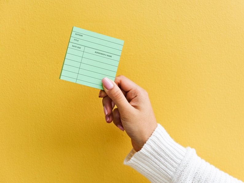 May include: A green library card with lines for author, title, date due, and borrower's name.
