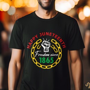 May include: Black t-shirt with a graphic design of a raised fist breaking free from a chain link circle. The text "Happy Juneteenth Freedom since 1865" is inside the circle.