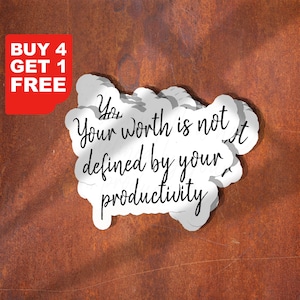 May include: A white sticker with the text "Your worth is not defined by your productivity" in black script. A red rectangle in the upper left corner reads "BUY 4 GET 1 FREE". The sticker is on a textured, brown background.