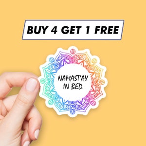May include: A white sticker with a rainbow mandala design and the text "Namast'ay in bed".