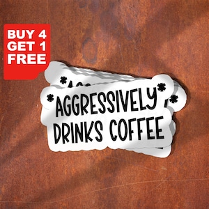 May include: White stickers with the text "AGGRESSIVELY DRINKS COFFEE" in a black, bold font. The stickers have a cloud-like shape and are stacked on top of each other. A red rectangle with white text that says "BUY 4 GET 1 FREE" is in the upper left corner.