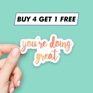 May include: A sticker with an orange and yellow gradient design that says "you're doing great".