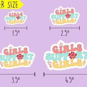 May include: Four different sizes of stickers with the text "Girls Support Girls" in a retro font. The stickers are in pink, blue, and yellow with a flower and lightning bolt graphic. The stickers are 1.5 inches, 2.5 inches, 3.5 inches, and 4.5 inches wide.