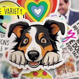 May include: A collection of colorful stickers featuring a smiling face, a rainbow heart, a dog peeking over the edge, a pizza slice, and a sticker with the text "I am not responsible that my wife does you talk".