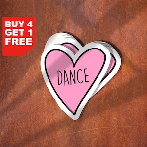 Peut inclure: Plusieurs autocollants en forme de cœur avec un intérieur rose et le mot "DANCE" en noir. Chaque autocollant a un contour noir et une bordure blanche. Un rectangle rouge avec le texte blanc "BUY 4 GET 1 FREE" est en haut à gauche.