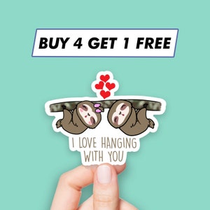 May include: A sticker with two cartoon sloths hanging from a branch, with hearts above them. The text reads "I love hanging with you".