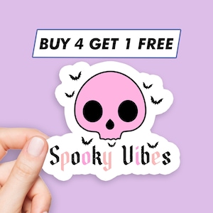 May include: Pink skull sticker with the text "Spooky Vibes" and bats flying around it. The sticker has a white border and a white background. The text "Buy 4 Get 1 Free" is at the top of the image.