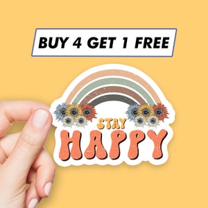 Puede incluir: Una pegatina con un arcoíris, flores y el texto "Stay Happy".