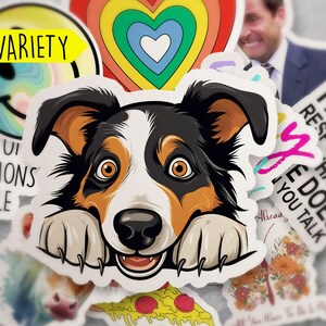 May include: A collection of stickers featuring a variety of designs, including a smiling face, a rainbow heart, a dog peeking over the edge, a pizza slice, and a sticker that says "I am not responsible that my wife does you talk".