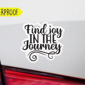 May include: White car with a black vinyl sticker that says "Find joy in the journey".