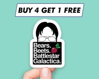 May include: A white sticker with a black and white illustration of a man with glasses and the text "Bears. Beets. Battlestar Galactica." with a red beet illustration. The sticker has a white border and the text "BUY 4 GET 1 FREE" is on a blue banner above the sticker.
