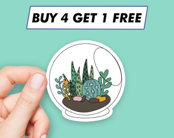 May include: A white sticker with a clear glass dome containing a variety of green succulents and a small cactus. The text "BUY 4 GET 1 FREE" is printed on a blue banner above the sticker.