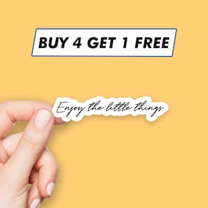 May include: A white sticker with the text "Enjoy the little things" on a yellow background. A blue banner above the sticker reads "BUY 4 GET 1 FREE".