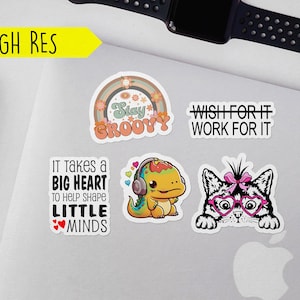 May include: Five colorful stickers with different designs and sayings. The stickers feature a rainbow with the words "Stay Groovy", a dinosaur wearing headphones with the words "It takes a big heart to help shape little minds", a cat wearing heart-shaped glasses with the words "Wish for it work for it", and two other stickers with text that is too small to read.