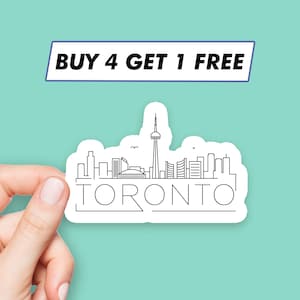 May include: White sticker with a black outline of the Toronto skyline, including the CN Tower. The text "BUY 4 GET 1 FREE" is above the skyline and the text "TORONTO" is below the skyline.