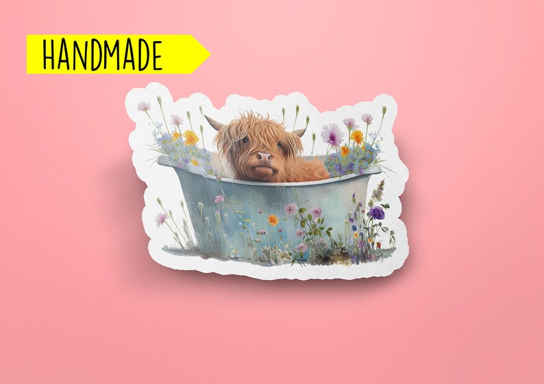 May include: A handmade sticker featuring a Highland cow taking a bath in a blue tub surrounded by colorful wildflowers.