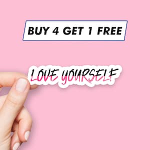 May include: A white sticker with pink and black lettering that says "LOVE YOURSELF" on a pink background. A hand is holding the sticker. The text "BUY 4 GET 1 FREE" is in a blue rectangle at the top of the image.