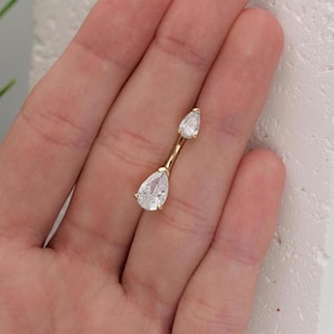 Puede incluir: Joyer&iacute;a corporal de oro con dos piedras transparentes en forma de l&aacute;grima.