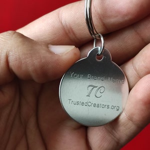 May include: A silver keychain with a round tag that says "Your Brand Name TC TrustedCreators.org"
