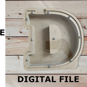 May include: A wooden cutout of the letter "D" with a decorative design. The cutout is on a woodgrain background. The text "DIGITAL FILE" is below the cutout.