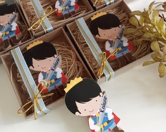 May include: Small cardboard boxes with a prince character cutout, each box has a blue and gold ribbon and the name "Kaisar" written on it.