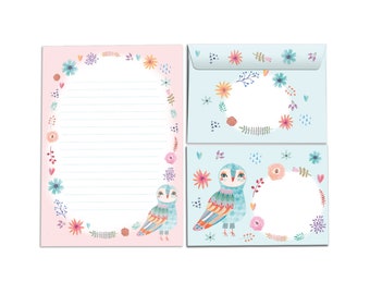 May include: A set of stationery featuring a pink and blue design with floral wreaths and owls. The set includes a letter writing sheet and two envelopes.