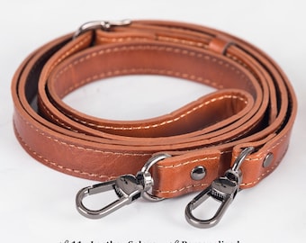 May include: A brown leather strap with silver hardware and stitching. The strap is coiled and ready to be attached to a bag or purse.  The text "11 - Leather Colors" and "Personalized" is visible at the bottom of the image.