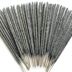 May include: A bundle of grey incense sticks, tied together at the bottom.