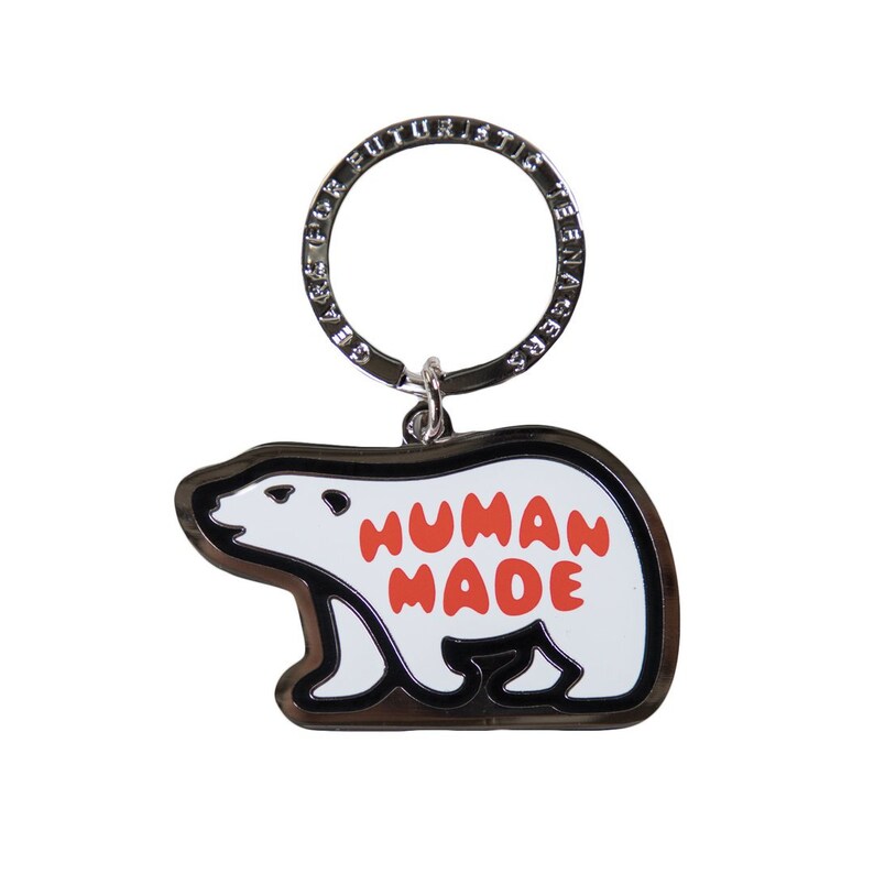 May include: A silver key chain with a white polar bear charm. The bear has the words "HUMAN MADE" in red lettering on its belly.