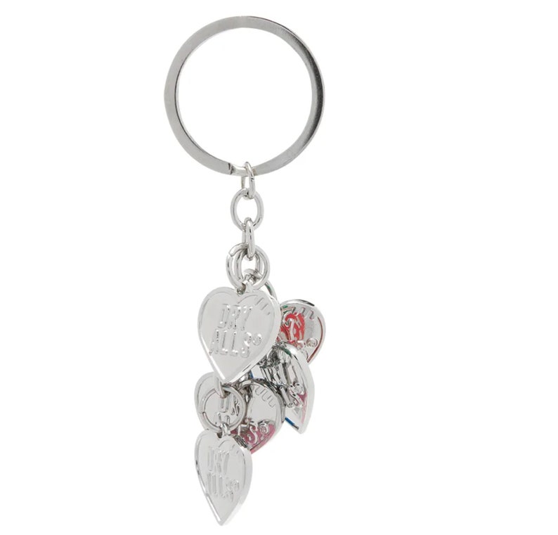 May include: Silver keychain with a silver ring and multiple silver heart-shaped charms. The charms have different engravings, including "My All" and "Love You".