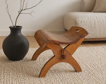 An antique Scandinavian hand-crafted stool made from solid pine.