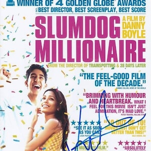 May include: Movie poster for the film Slumdog Millionaire, featuring the actors Dev Patel and Frieda Pinto. The poster is decorated with confetti and includes several positive reviews from critics.