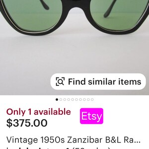 May include: Vintage black cat-eye sunglasses with white and black wavy trim. The lenses are green. The sunglasses are for sale on Etsy for $375.00.