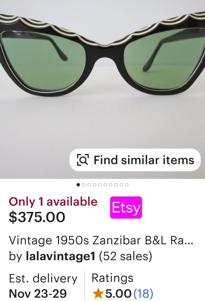 May include: Vintage black cat-eye sunglasses with white and black wavy trim. The lenses are green. The sunglasses are for sale on Etsy for $375.00.