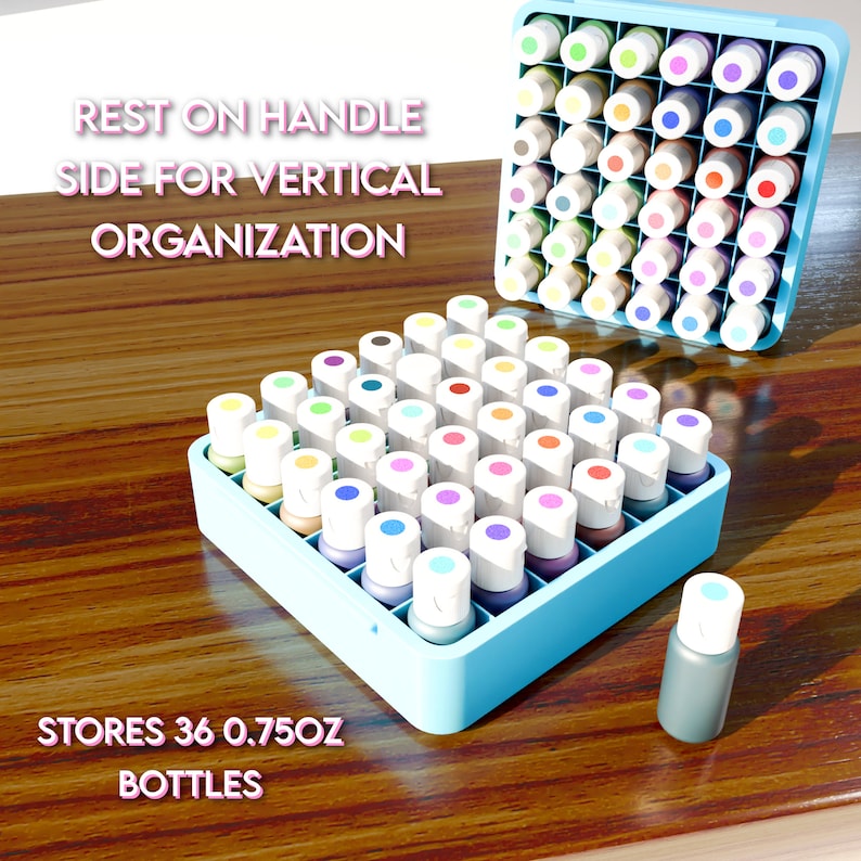 May include: Blue plastic organizer with 36 slots for storing 0.75 oz bottles.  The organizer is filled with colorful bottles.  "REST ON HANDLE SIDE FOR VERTICAL ORGANIZATION" and "STORES 36 0.75OZ BOTTLES" are printed on the wooden surface.