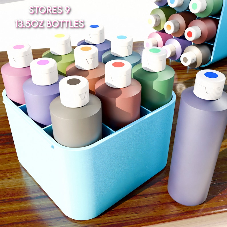 May include: A set of nine 13.5 oz bottles of paint in various colors, organized in a blue plastic storage container. The bottles have white lids with a small colored dot on top.  STORES 9 13.5OZ BOTTLES is written on the container.