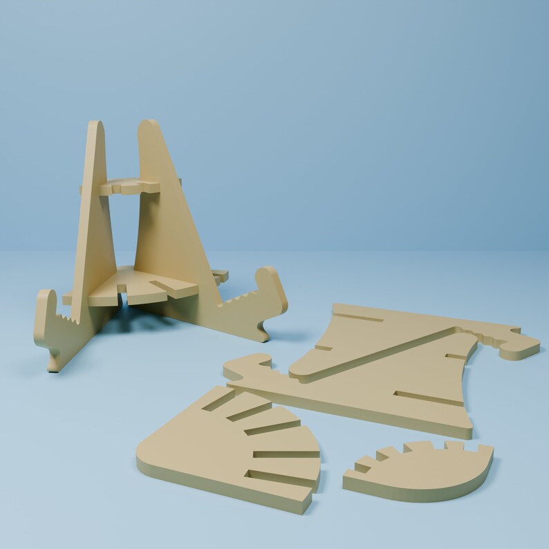 May include: A disassembled wooden phone stand made of five pieces. The stand is made of light brown wood and is designed to hold a phone upright.